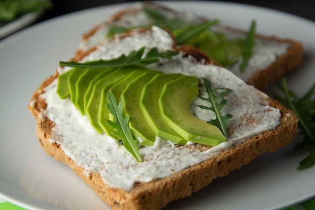 Avocado sandwich toast bread made with fresh sliced avocado, cream cheese. 