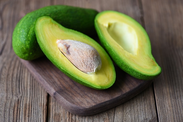 Avocado sliced half on wooden cutting board for avocado salad