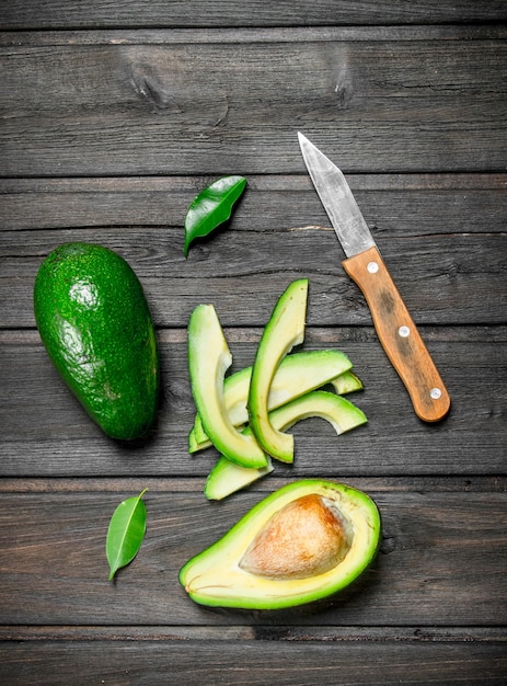 Avocado and small slices of avocado with a knife