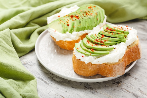 avocado toasts with spices and cream cheese