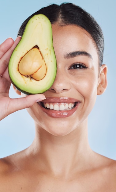 Avocado wellness and skincare woman portrait on blue studio background and mockup Young model with natural organic nutrition diet for face and healthcare with green clean and healthy lifestyle