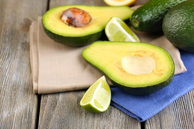 Avocado with limes on table close up