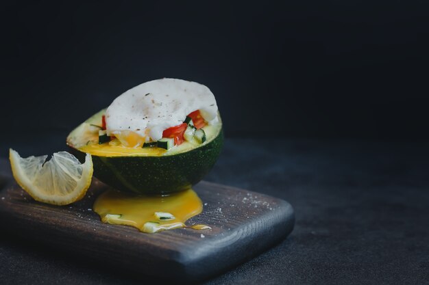 Avocado with poached egg and tomato and cucumber salad