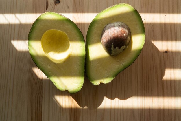 Avocado on wooden background avocado fruit raw fruits healthy
green food half avocado