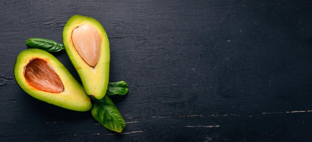 Avocado on a wooden background. Top view. Free space for your text.