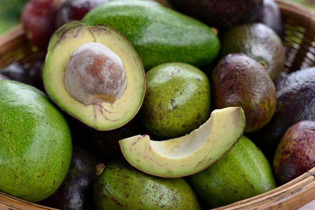 Avocado on an wooden basket half on a fruit concept healthy food