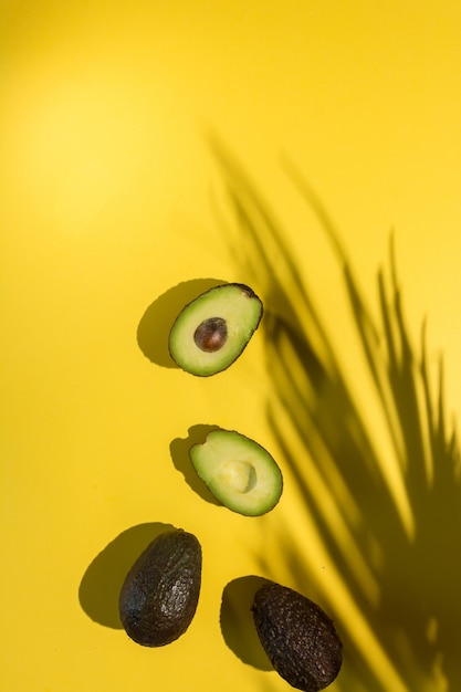 Avocados cut on yellow isolated