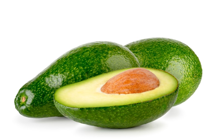 Photo avocados and a half with a seed isolated