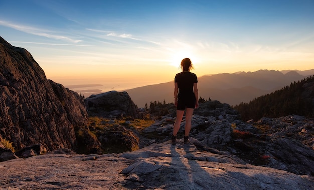 Avontuurlijke vrouwelijke wandelaar op de top van het Canadese berglandschap Zonnige zonsondergang Hemel Top van Mt Seymour bij Vancouver Brits-Columbia Canada Avontuur Reizen Concept