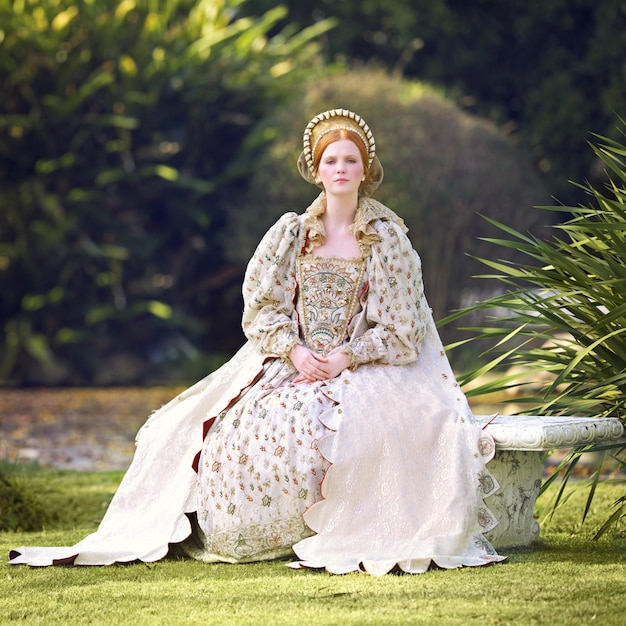 Awaiting her king Portrait of a noble woman sitting outdoors on palace grounds