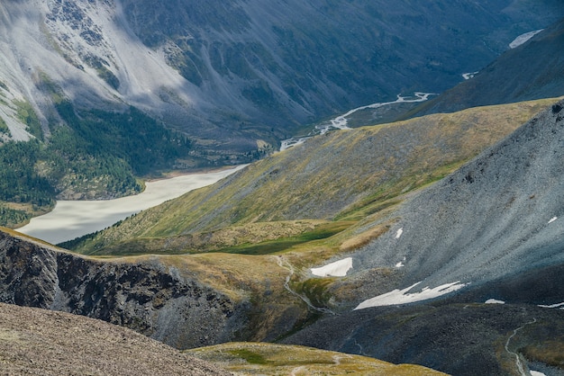 Awesome aerial view to beautiful valley with mountains lake and giant textured slopes