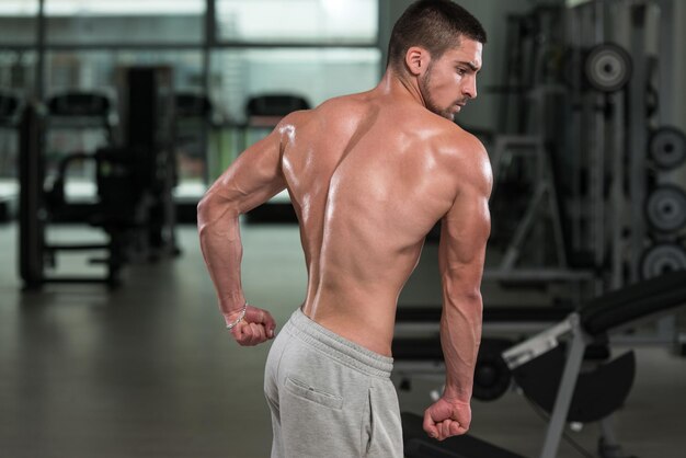 Awesome Bodybuilder Showing His Muscles And Posing In Gym