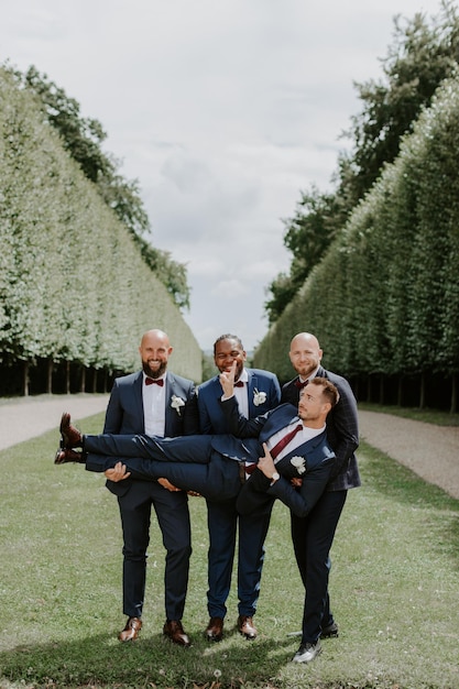 Premium Photo | Awesome Groom And Groomsmen Getting Crazy In The Forest And  Performing Tricks On A Wedding Day.