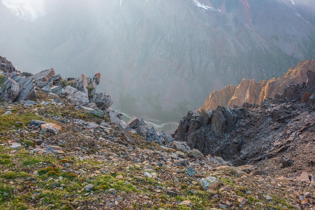 Awesome mountain view from cliff at very high altitude Scenic landscape with beautiful sharp rocks near precipice and couloirs in sunlight Beautiful mountain scenery on abyss edge with sharp stones