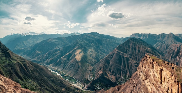 awesome panoramic view from pass to mountain valley in sunlight 