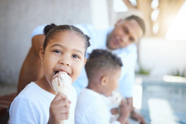 Awesome time with dad. shot of a brother and sister enjoying an ice-cream while bonding with their father outside.