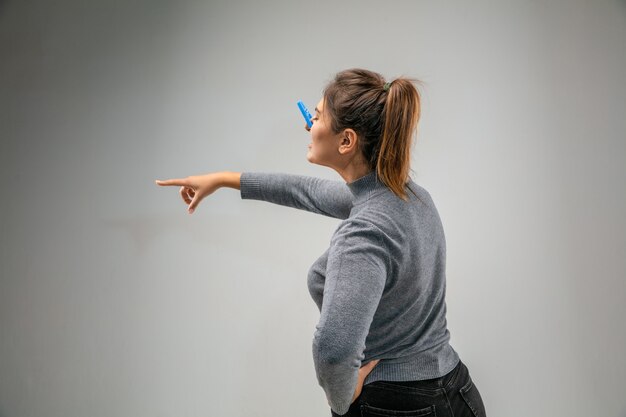 Awful. Caucasian woman wearing the respiratory protection pin clasp against air pollution and dust particles exceed the safety limits. Healthcare, environmental, ecology concept. Allergy, headache.