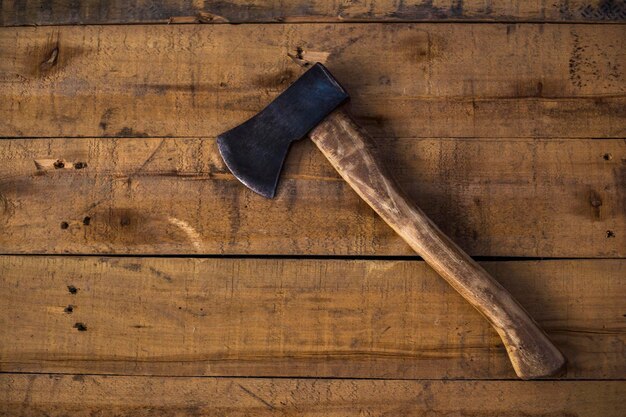 Photo ax on isolated wooden background