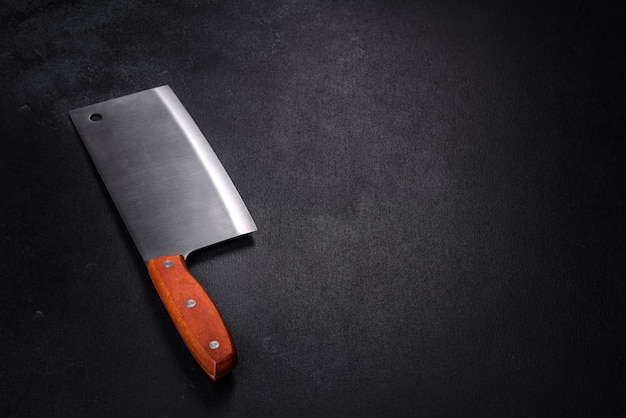 An axe for cutting meat on a dark concrete background