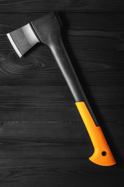 Axe icon flat isolated on a black wooden background