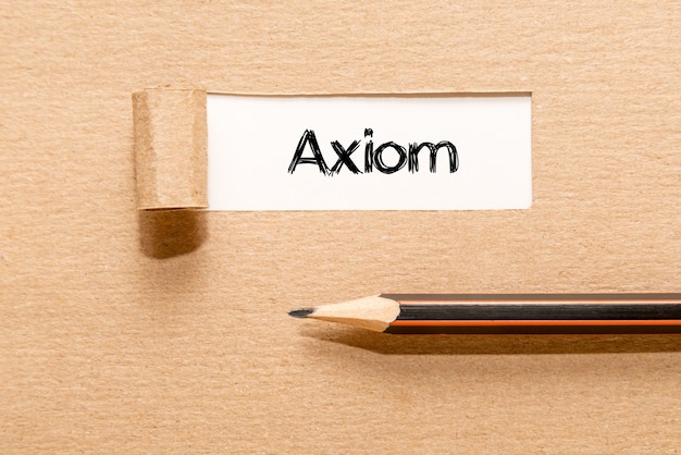 AXIOM, text on white paper appearing behind torn brown paper and pencil