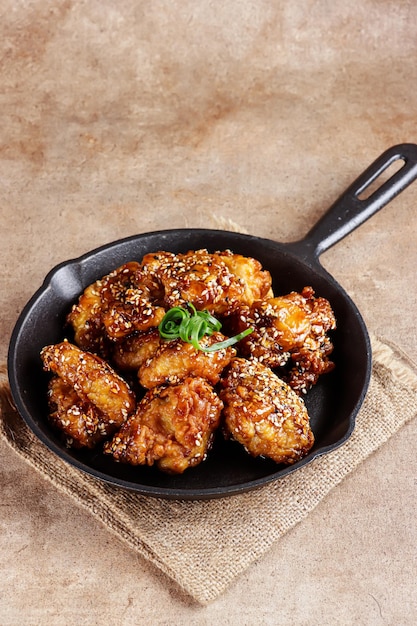 Ayam goreng Korea or Yangnyeom chicken is a fried chicken with Korean sauce with sesame seeds