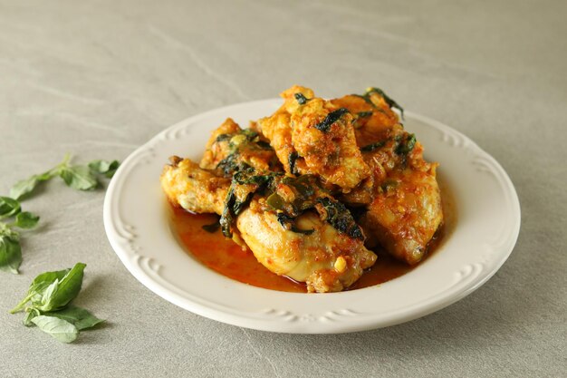 ayam woku, or turmeric spiced chicken with Asian basil  is Indonesia traditional cuisine.