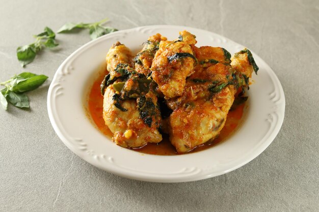 ayam woku, or turmeric spiced chicken with Asian basil is Indonesia traditional cuisine.