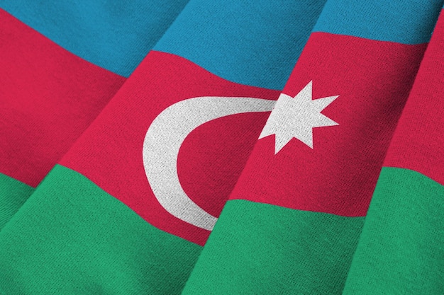 Azerbaijan flag with big folds waving close up under the studio light indoors the official symbols and colors in banner