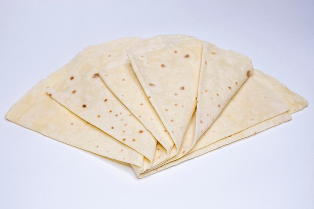 Azerbaijani lavash lies on a white table top view on lavash baking from wheat flour national bread