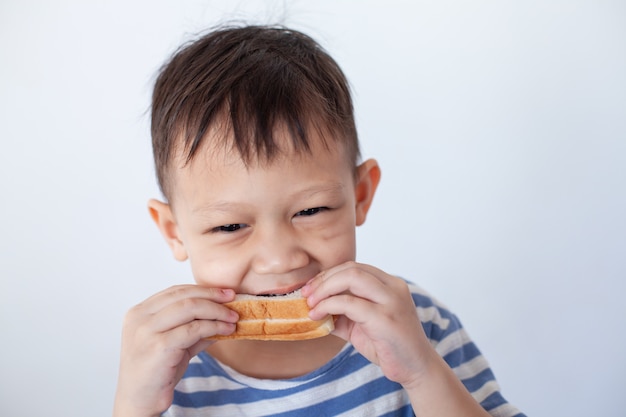 Aziaat jongetje dat brood eet voordat naar school gaat