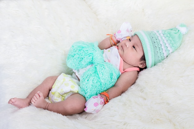Aziatische baby en groen groot lint op wollen