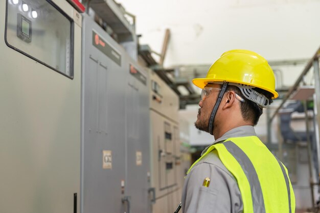 Aziatische elektrische ingenieur met klembord voor het controleren en bewaken van het elektrische systeem in de controlekamer Technicus thailand mensen aan het werk