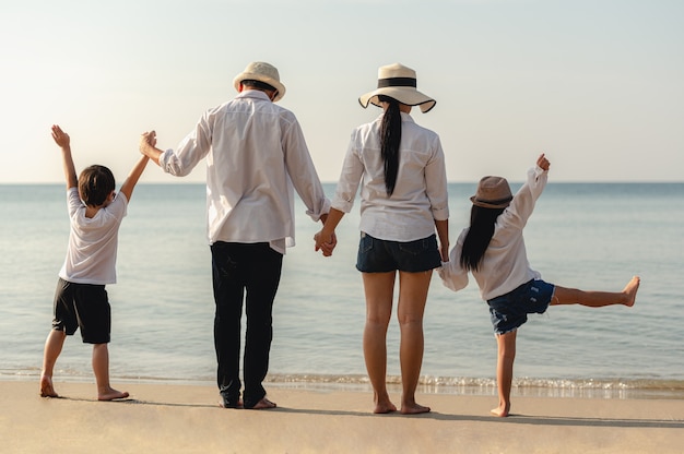 Aziatische gelukkige familie geniet van ontspannen op het strand, reizen, vakantie en lifestyle concept.