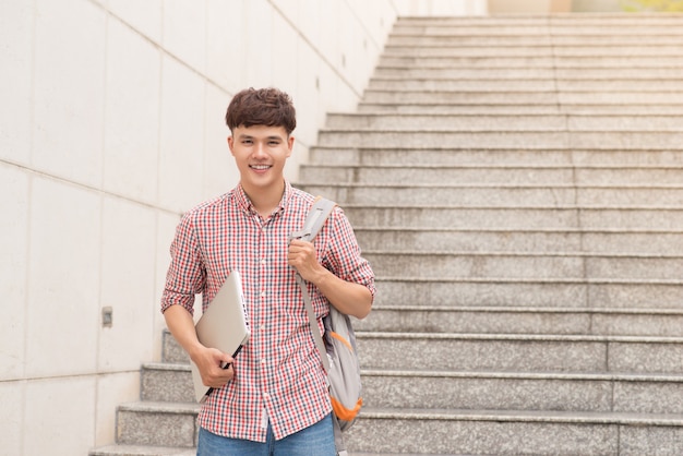 Aziatische jonge mannelijke student op universitaire school