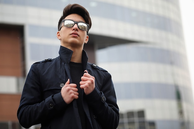 Aziatische jonge volwassen man op straat poseren voor de camera