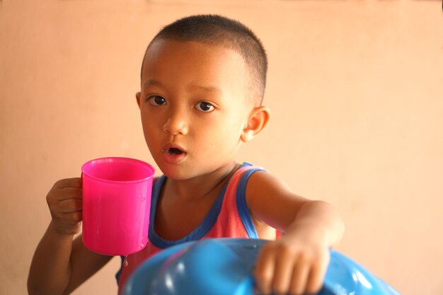 Aziatische jongen drinkwater om af te koelen