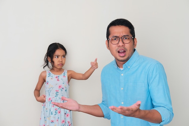 Aziatische kleine jongen wijst haar vader met boze uitdrukking