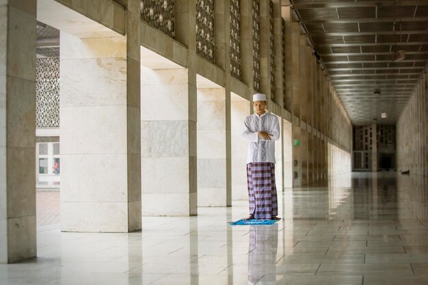 Aziatische man die salat doet op de Istiqlal-moskee