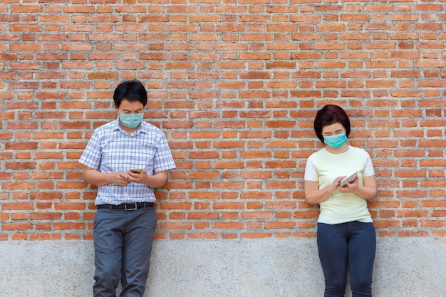 Aziatische mensen van middelbare leeftijd die een masker dragen en sociale afstand bewaren om de verspreiding van COVID-19 te voorkomen