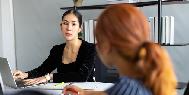 Aziatische ondernemer vrouw druk bezig met werken en vergaderen in het kantoor aan huis.