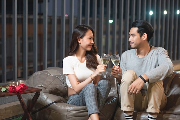 Aziatische paar toast wijn vieren in nachtclub