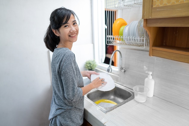 Aziatische vrouw afwas in de keuken