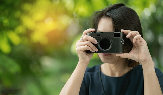 Aziatische vrouw met een camera, professionele fotograaf