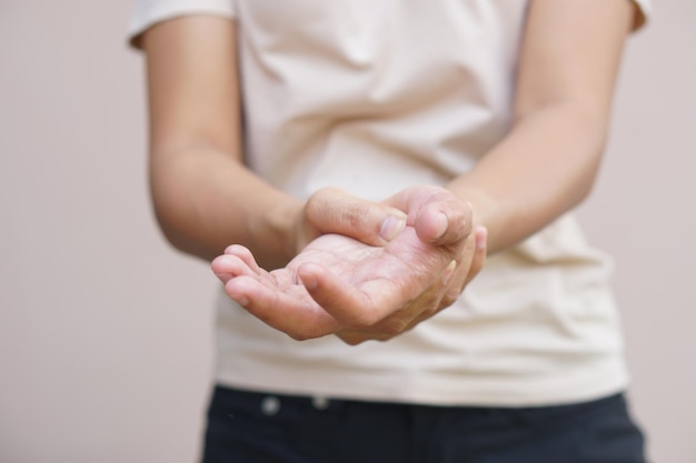 Aziatische vrouw met gevoelloosheid van de hand