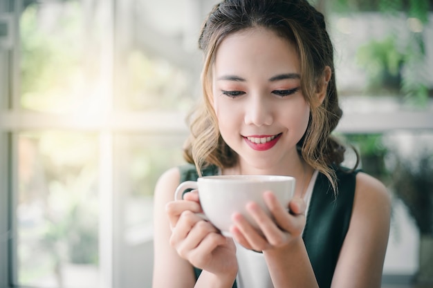 Aziatische vrouw met koffiekopje.