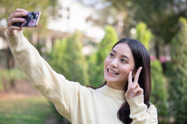 Aziatische vrouwen glimlachen zijn het maken van foto&#39;s en selfie