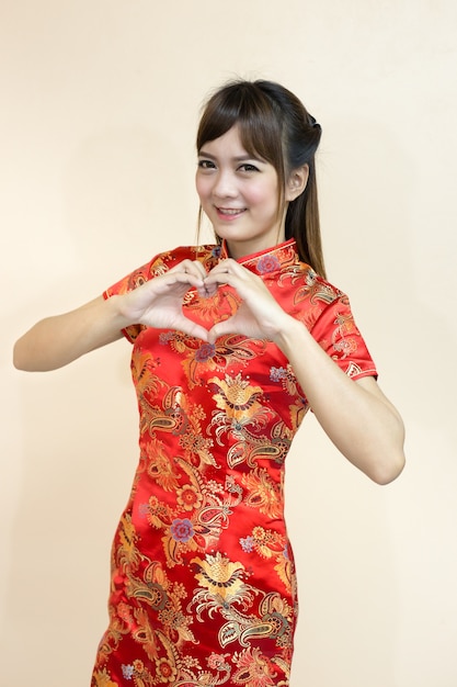 Aziatische vrouwengroet in traditionele Chinees of cheongsam