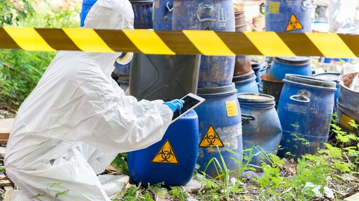 Aziatische wetenschappers dragen Chemisch beschermingspak controleer gevaar chemisch werken in een gevaarlijke zone om de gevaarlijke chemicaliën te verifiëren