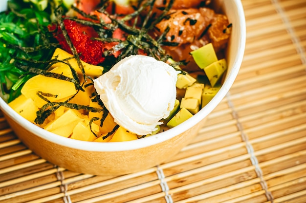 Aziatische zalmsalade met mango, roomkaas en groenten voor gezonde voeding, bezorgservice voor eten en online bestelconcept